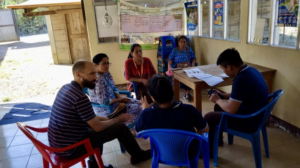 From left, TulaSalud’s program coordinator Stuart Davidson, TulaSalud health and gender equity specialist Sareen Ali, and TulaSalud manager of digital health Estela Cojoc Suram meet with frontline health workers in the village of Aldea San Luis Tontem in the department of Alta Verapaz. Photo courtesy TulaSalud