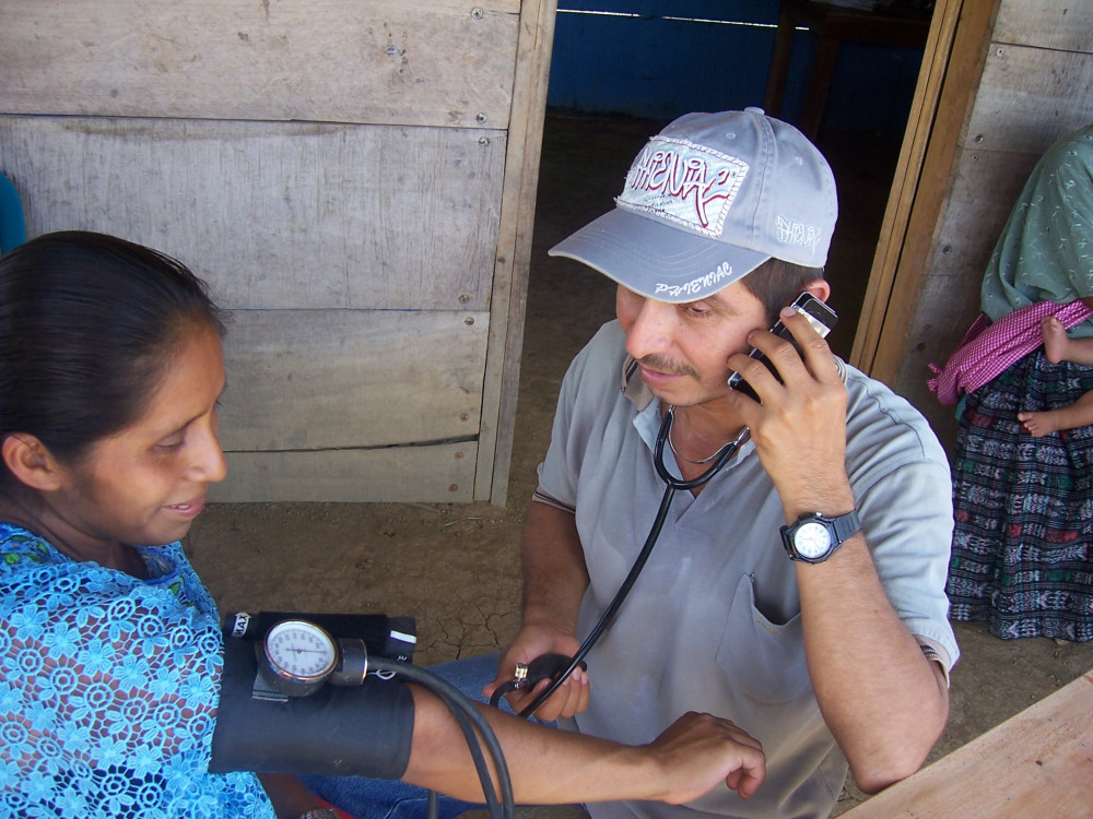 Healthcare worker treating patient in a remote location in Guatemala.
