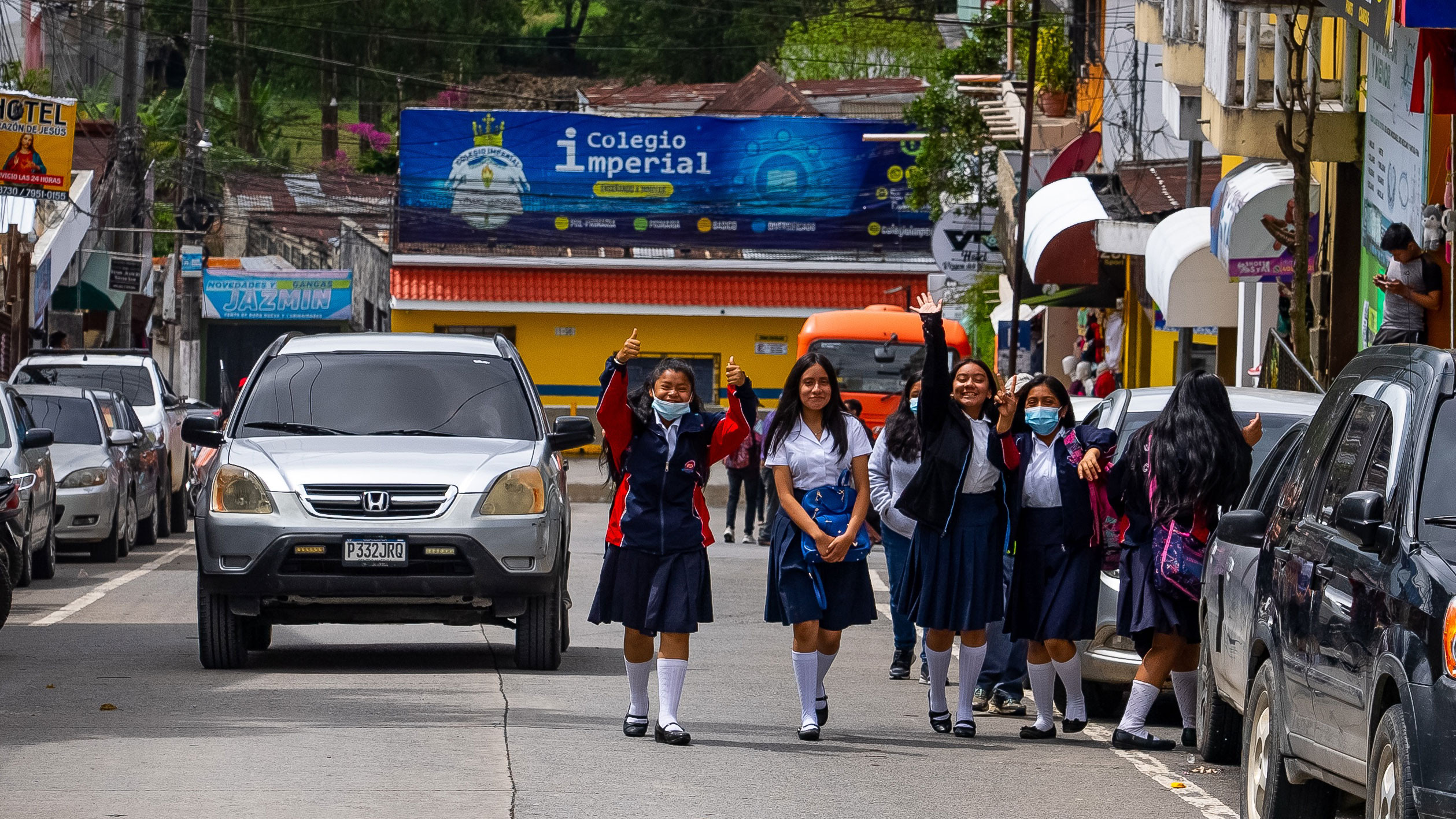 Young women walk home from school on a street in San Juan Chamelco in the department of Alta Verapaz, Guatemala.